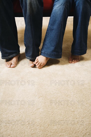 Couple playing footsie on carpet