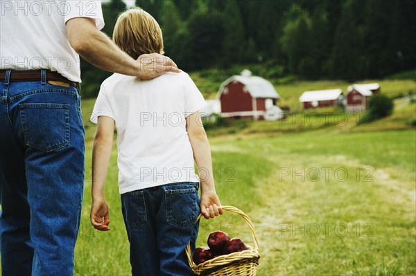 Father and son walking on farm