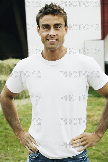Man with hands on hips on farm