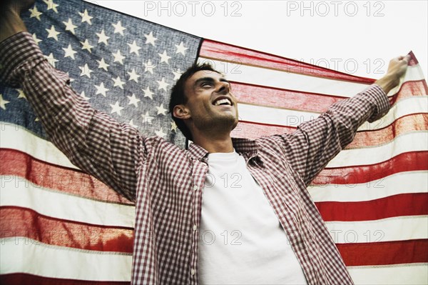 Man holding up American flag