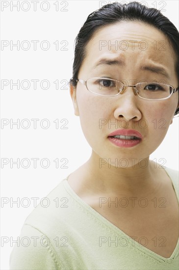 Portrait of Asian woman with brow furrowed