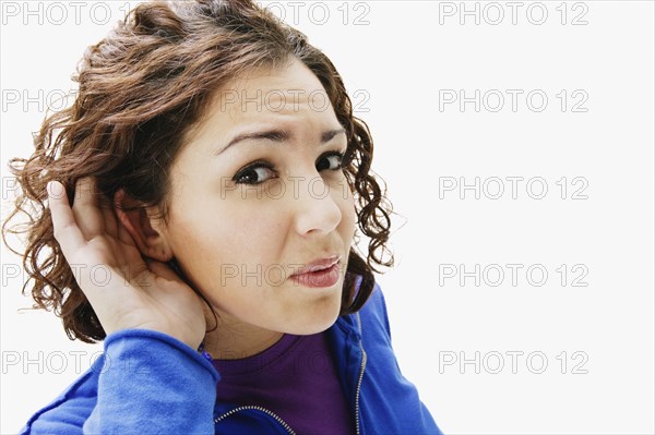 Portrait of woman holding hand up to ear