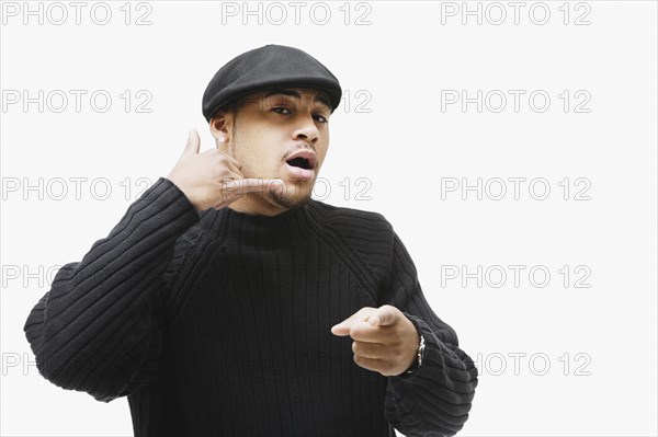 African man making telephone hand gesture and pointing