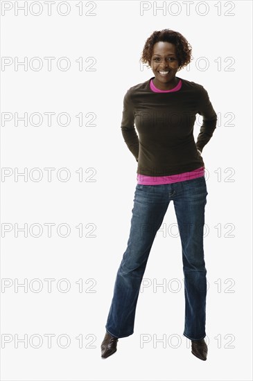 Portrait of African woman with hands behind back