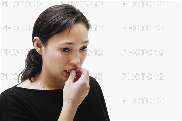 Portrait of Native American woman biting fingers