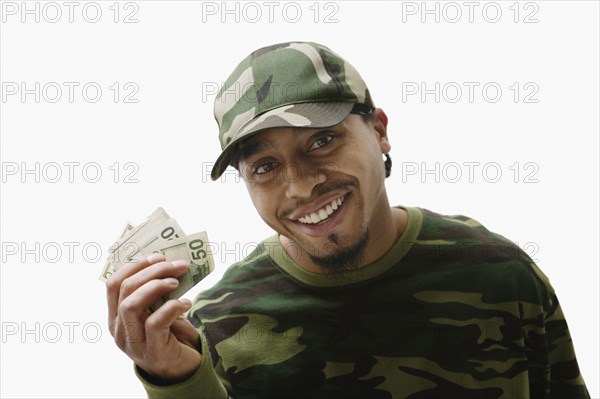 Portrait of African man holding handful of money