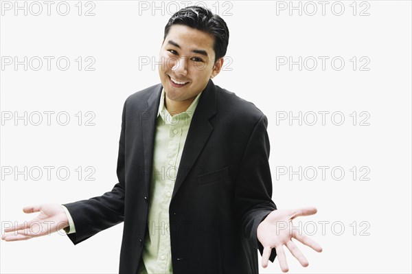 Portrait of Asian man shrugging shoulders