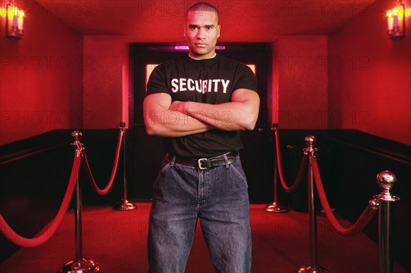 African male bouncer with arms crossed