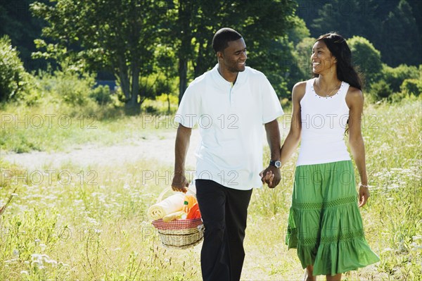 African couple carrying picnic basket