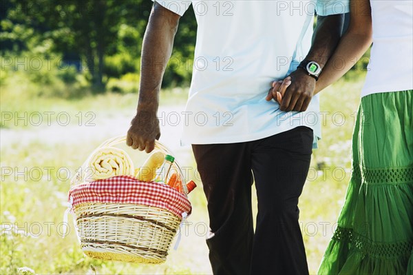 African couple carrying picnic basket