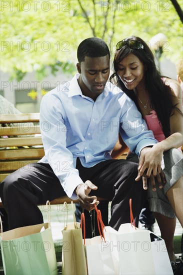 African couple looking at shopping bags