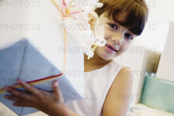 Hispanic girl holding gift