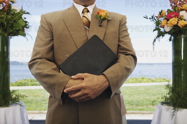 Hispanic man holding book