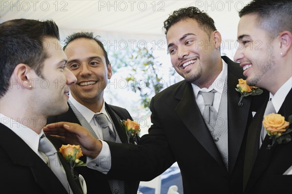 Multi-ethnic men wearing tuxedos