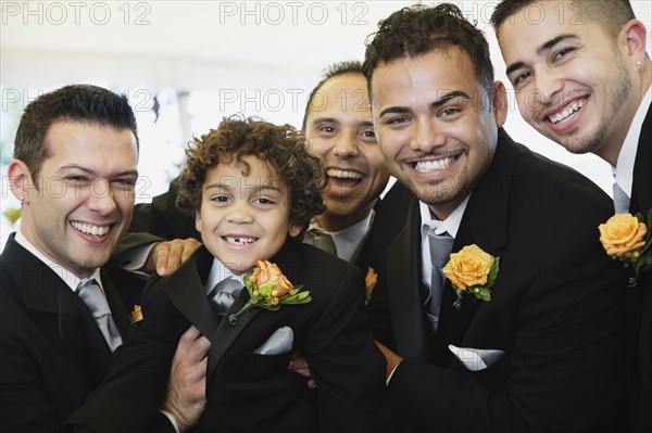 Multi-ethnic men and boy wearing tuxedos