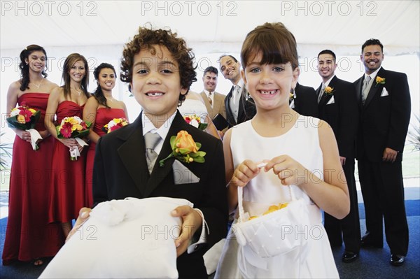 Hispanic boy and girl as ring bearer and flower girl