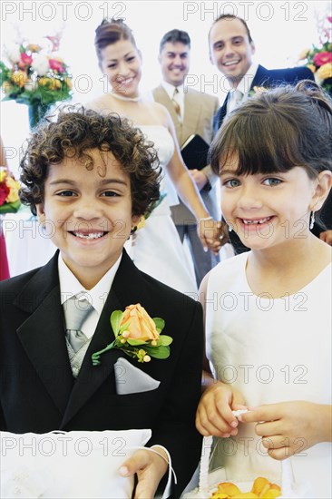 Hispanic boy and girl as ring bearer and flower girl