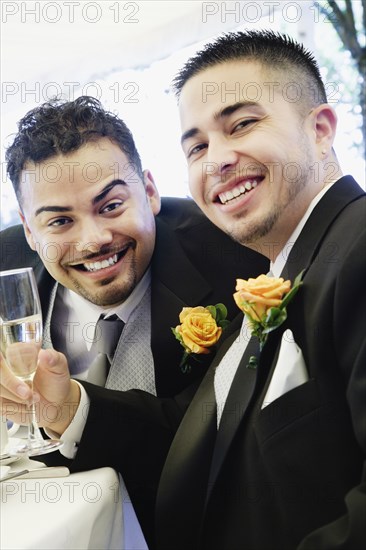 Multi-ethnic men wearing tuxedos