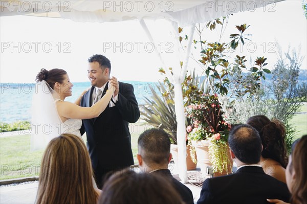 Multi-ethnic bride and groom dancing