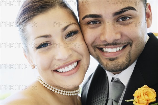 Multi-ethnic bride and groom hugging