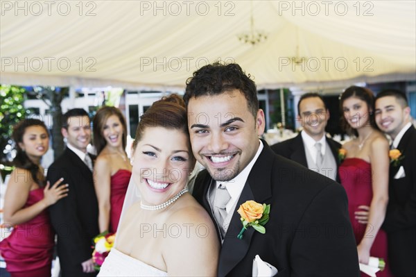 Multi-ethnic bride and groom hugging