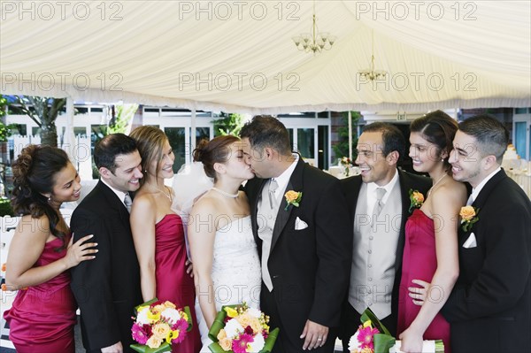 Multi-ethnic bride and groom kissing