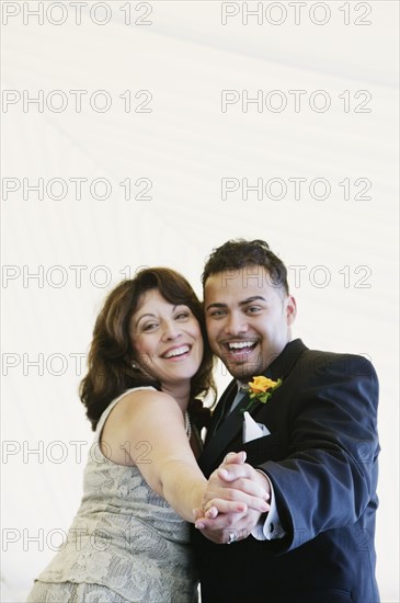 Groom dancing with mother at wedding