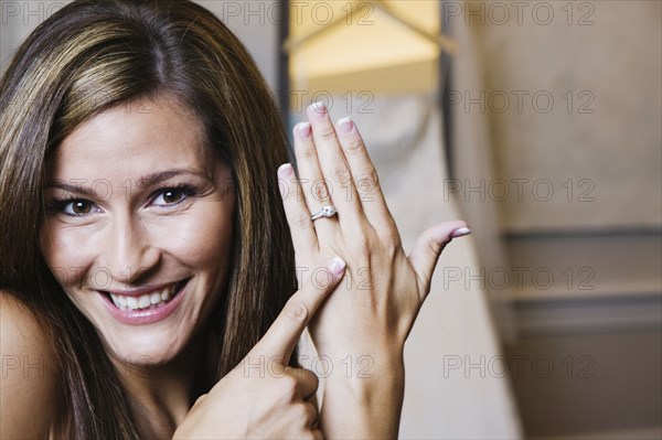 Bride pointing to ring