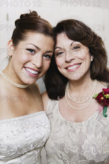 Bride and mother hugging