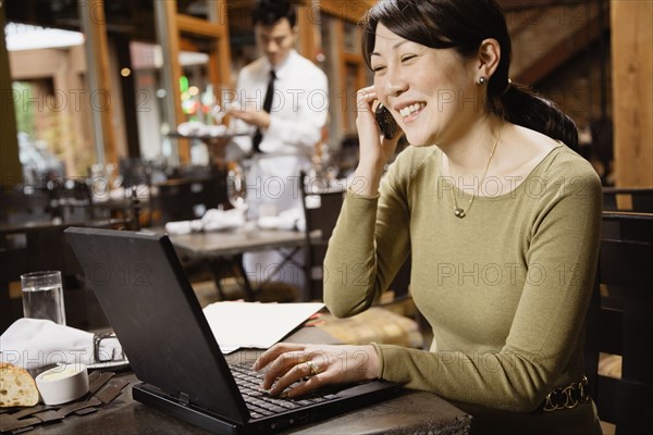 Asian businesswoman talking on cell phone