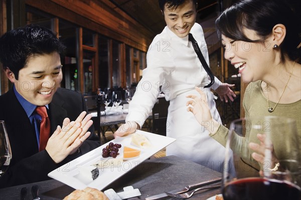 Asian couple eating at restaurant