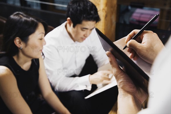 Asian couple ordering food at restaurant