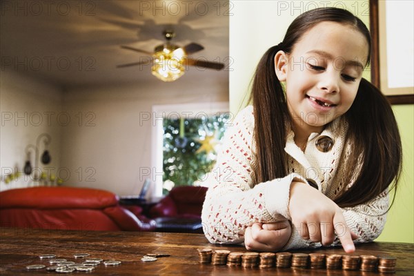 Asian girl counting coins