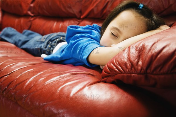 Asian girl sleeping on sofa