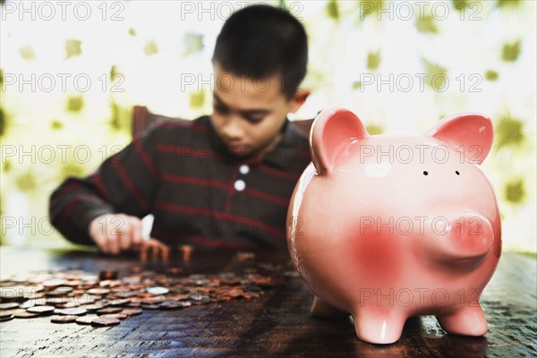 Asian boy counting coins