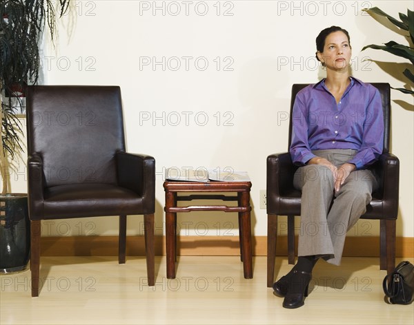 Mixed Race woman sitting in waiting area