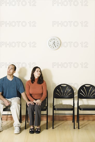 Multi-ethnic couple sitting in waiting area