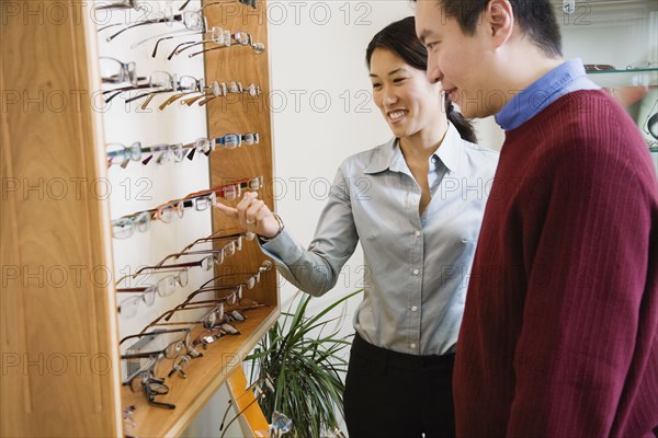 Asian couple shopping for eyeglasses