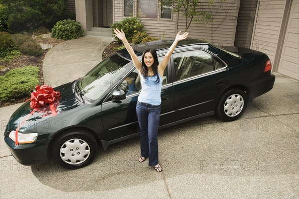 Asian teenager celebrating new car