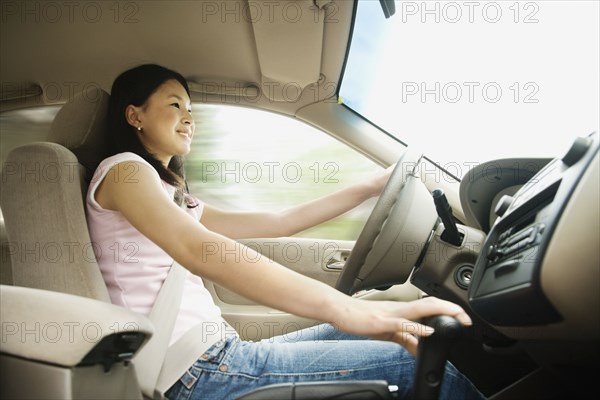 Asian teenager driving car
