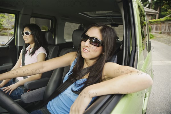 Asian teenagers driving in car