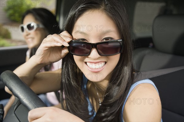 Asian teenagers driving in car