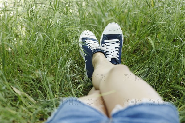 Asian woman laying in grass