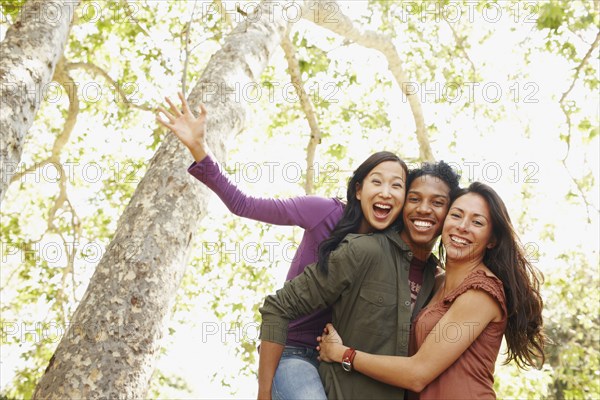 Multi-ethnic friends laughing outdoors