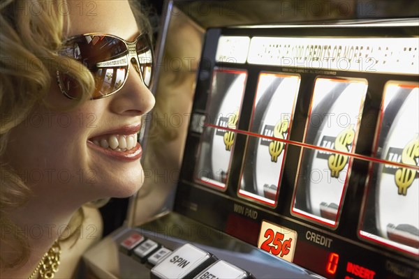 Young woman winning at the slot machine