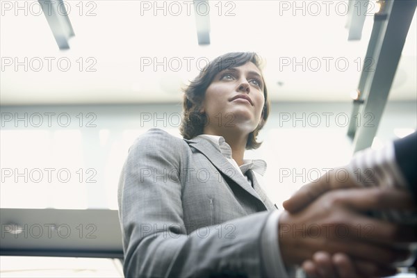 Hispanic businesswoman shaking hands