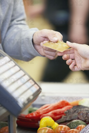 Man paying with credit card at grocery store