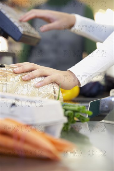 Cashier ringing up groceries