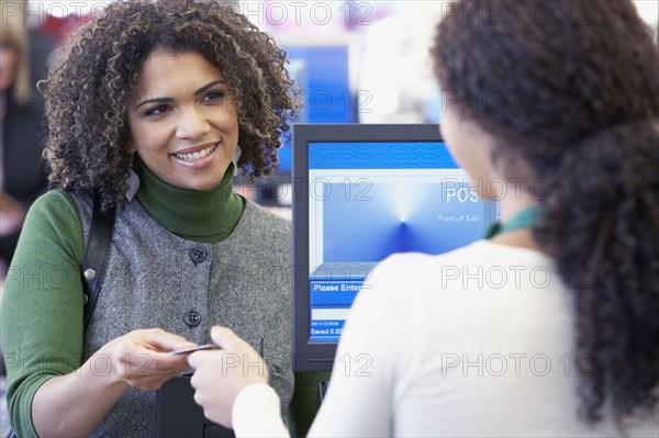 African woman paying with credit card