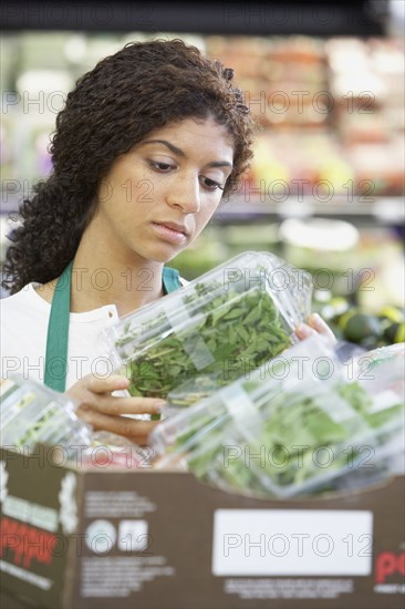 Mixed Race clerk in grocery store